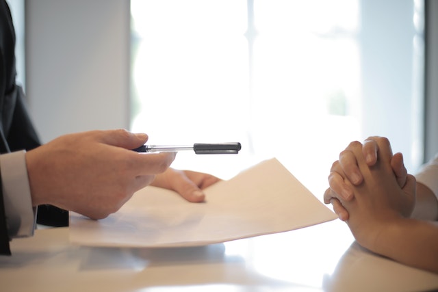 pictures of two hands and the one on the left is holding a paper and a pen and they are giving them to the person on the right